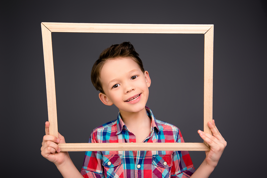 Boy holding picture frame